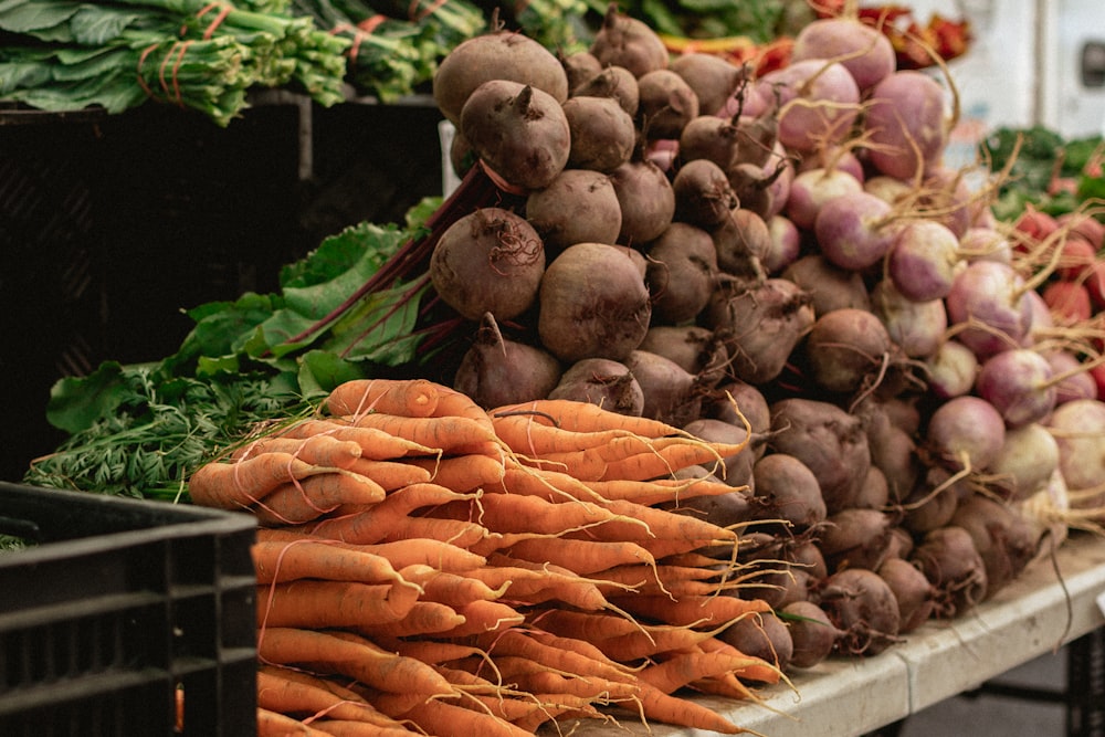 a bunch of carrots and radishes on a table