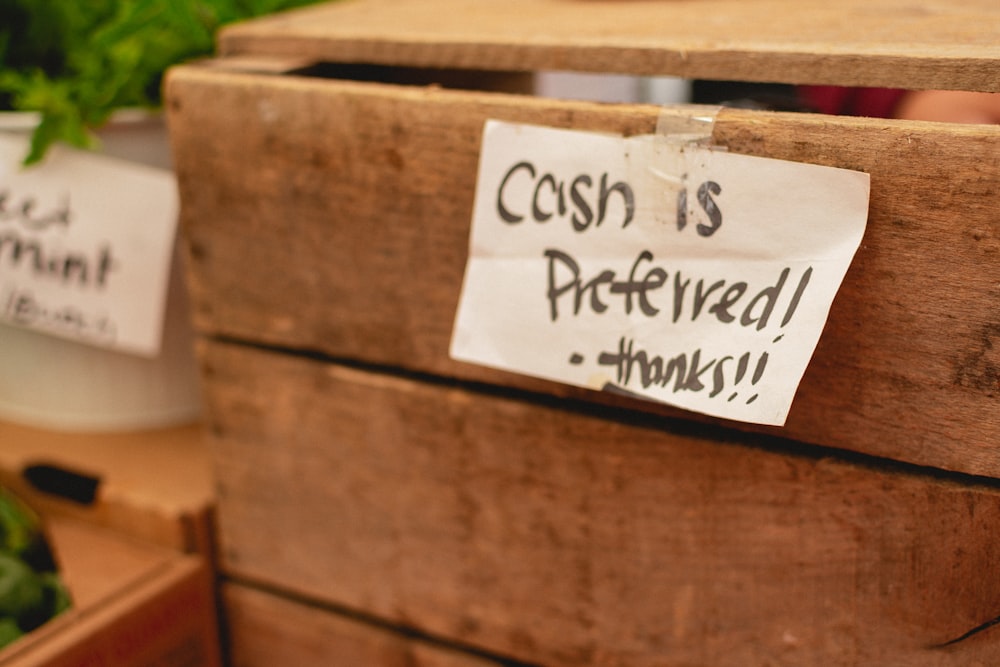 a close up of a wooden box with a sign on it