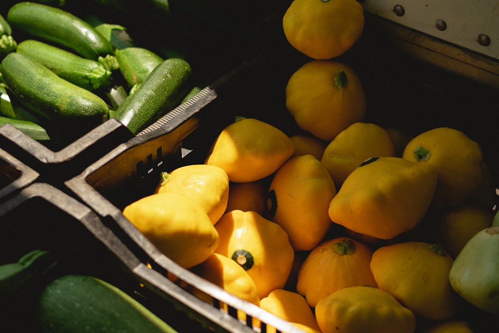 a basket of yellow peppers and cucumbers