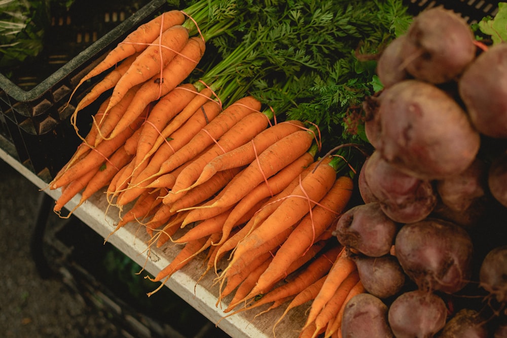 a bunch of carrots and other vegetables on a table