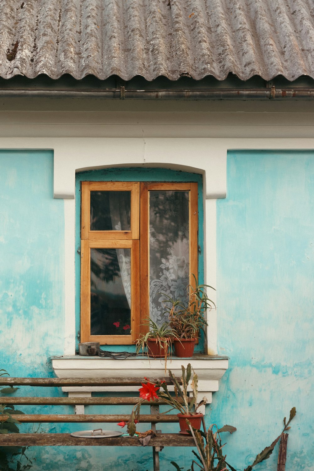 a wooden bench sitting in front of a window