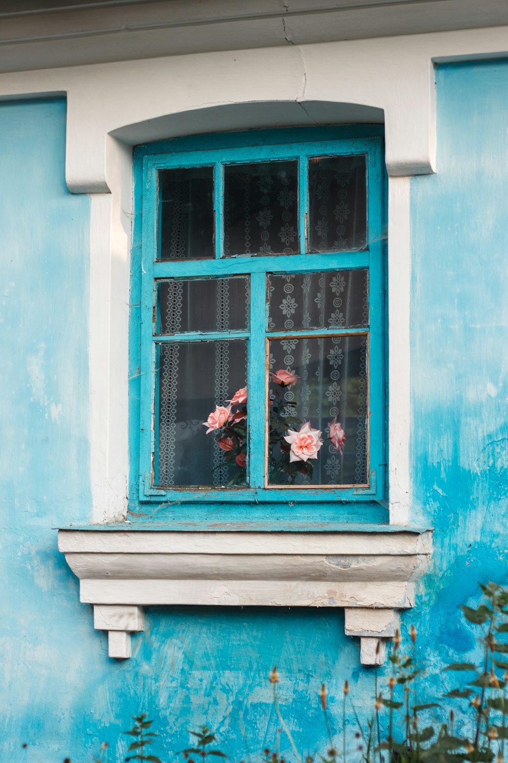 a blue and white building with a window