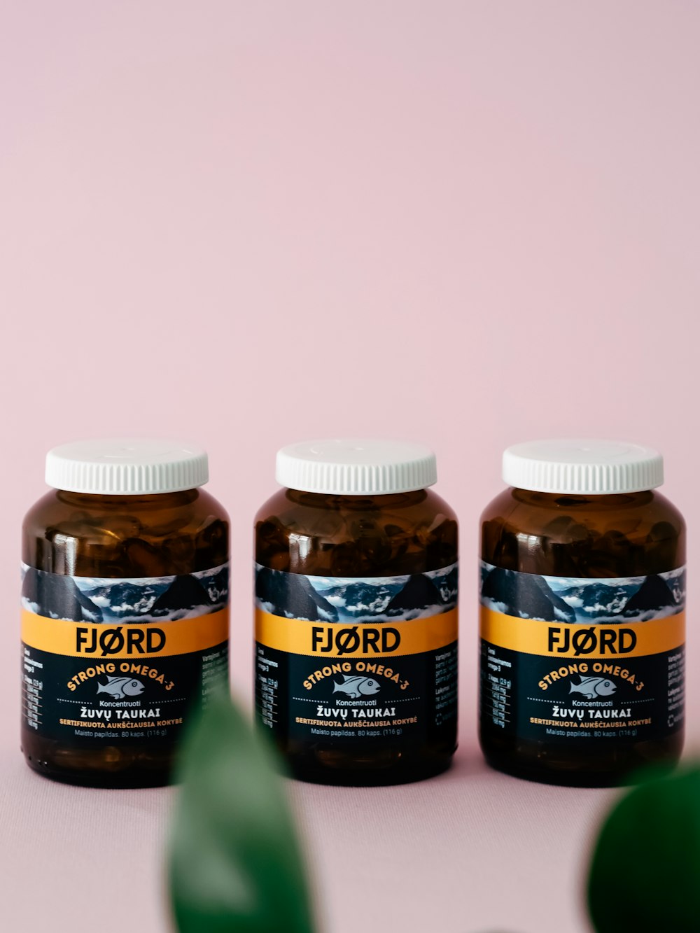 three jars of liquid sitting on top of a table