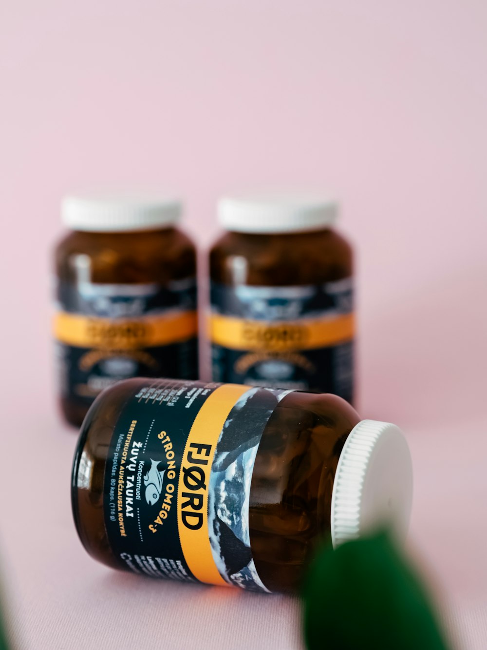 three bottles of fish oil sitting on a table