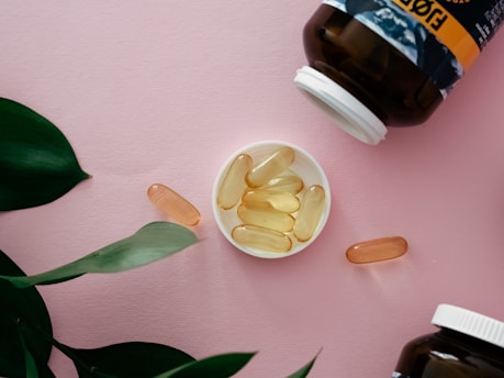 a bowl of fish oil next to a bottle of fish oil