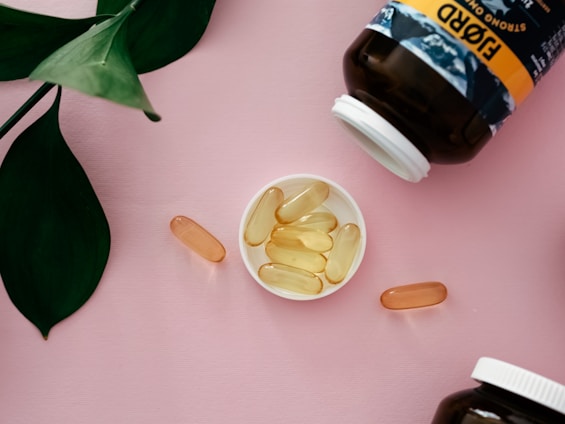 Close-up of Ozalyn capsules spilling out of a natural wooden bowl on a rustic table.