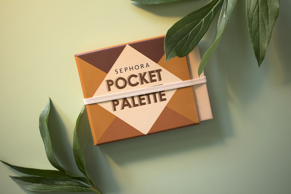 a box of pocket palee next to a plant
