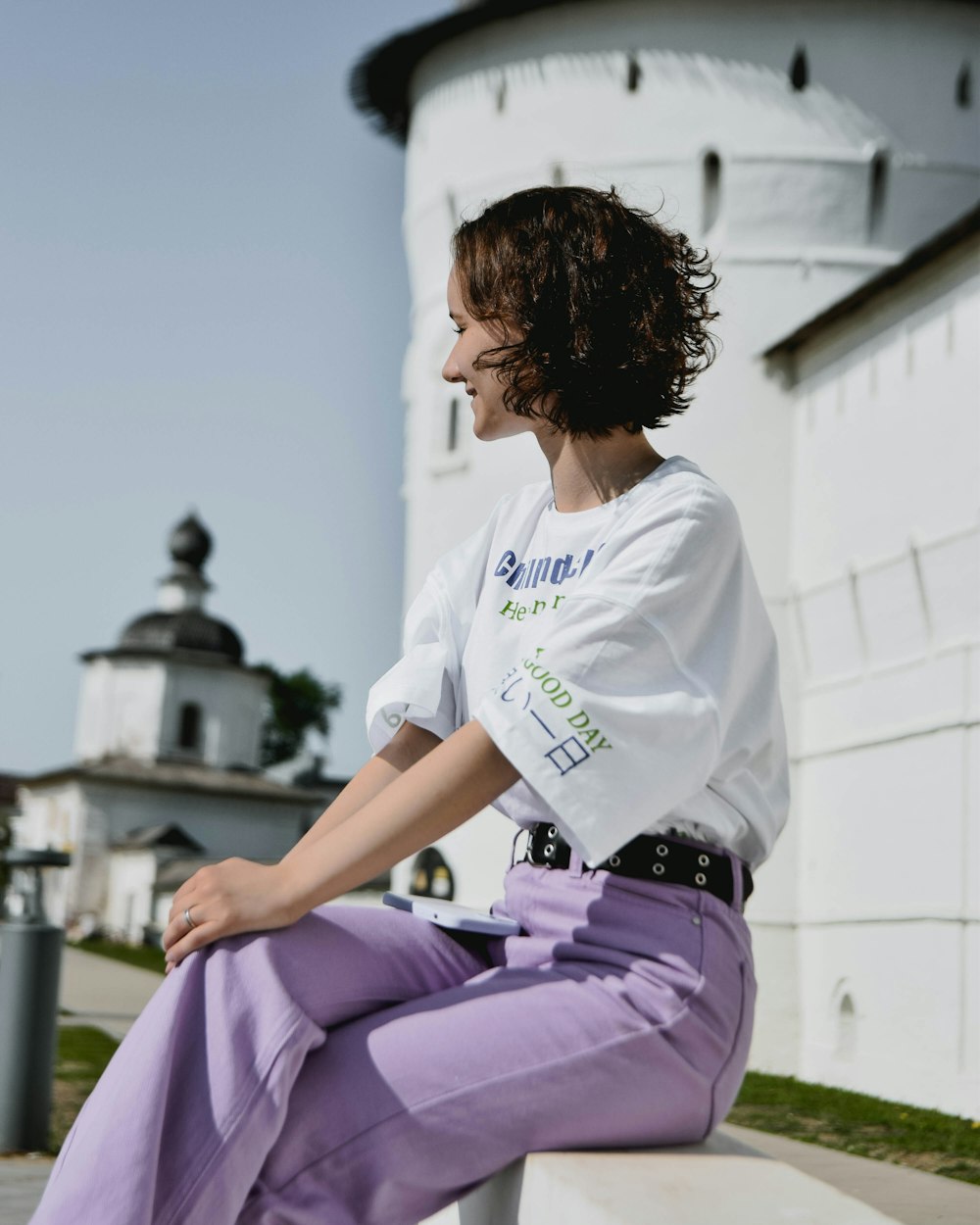 a woman in a white shirt and purple pants