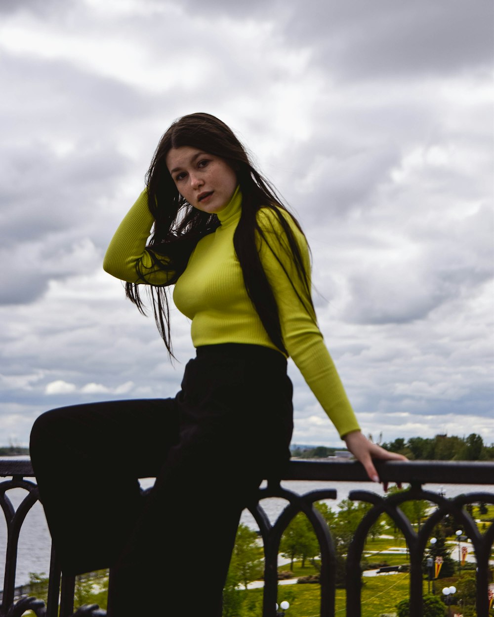 a woman in a yellow shirt and black pants