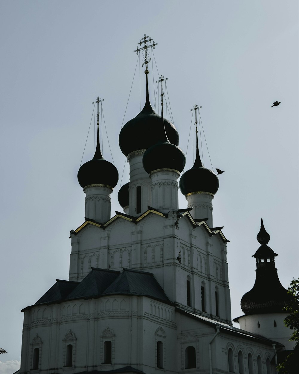 a church with three steeples and a cross on top