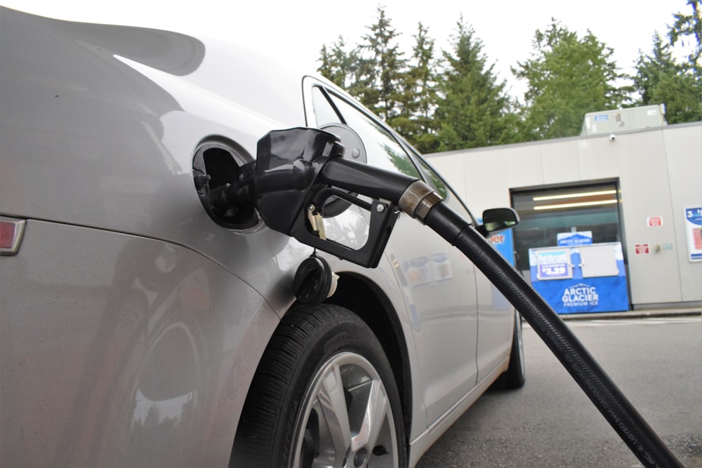 an electric car being charged at a gas station