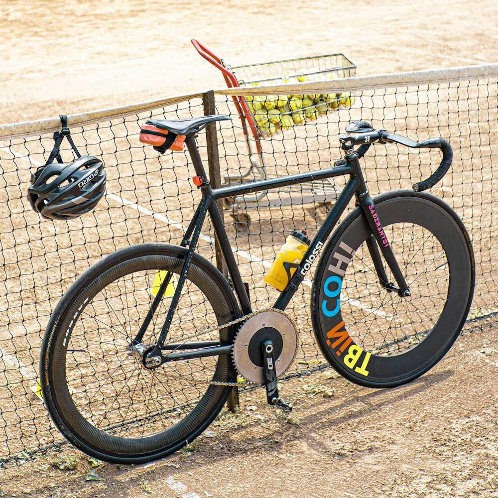 a bicycle parked next to a tennis net