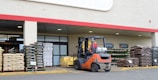 a forklift parked in front of a store