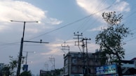 Wide shot of an urban electrical infrastructure with cables and transformers at dusk.