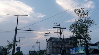 A cityscape at dusk showing 5G antennas integrated with electrical grid infrastructure.