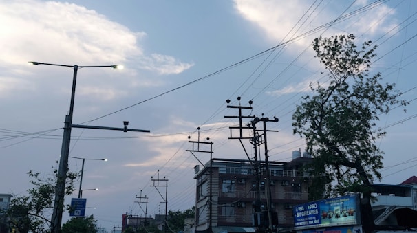 A cityscape at dusk showing 5G antennas integrated with electrical grid infrastructure.