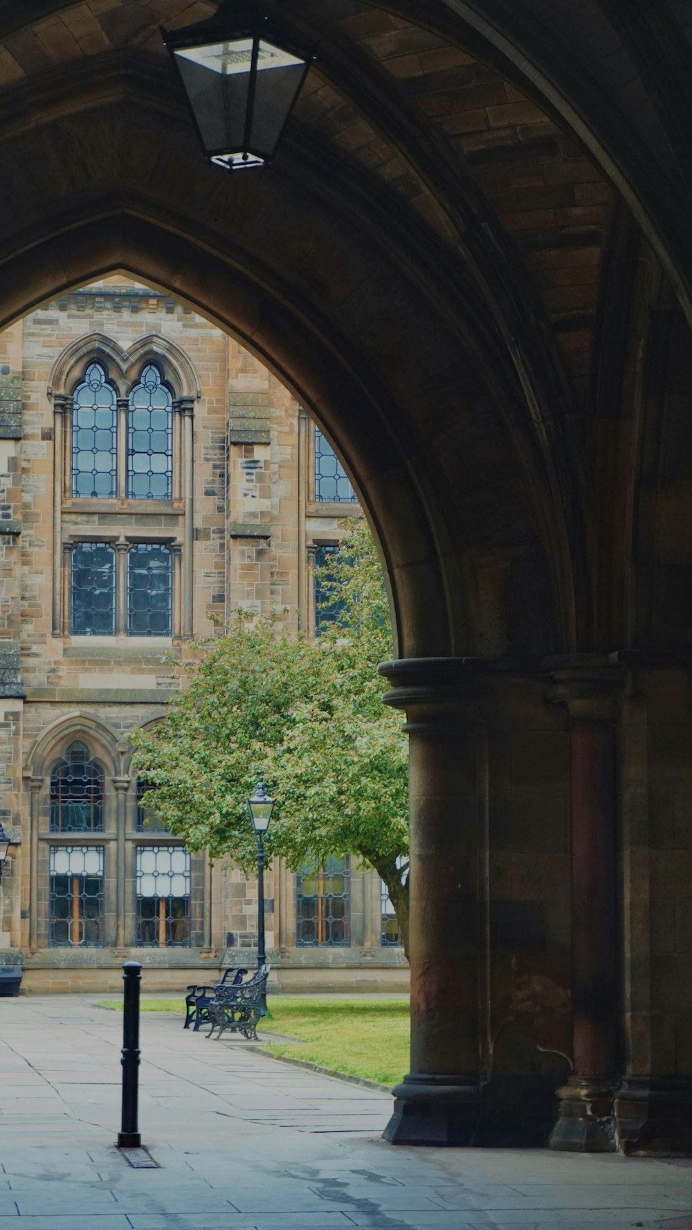 an archway leading to a building with a clock on it