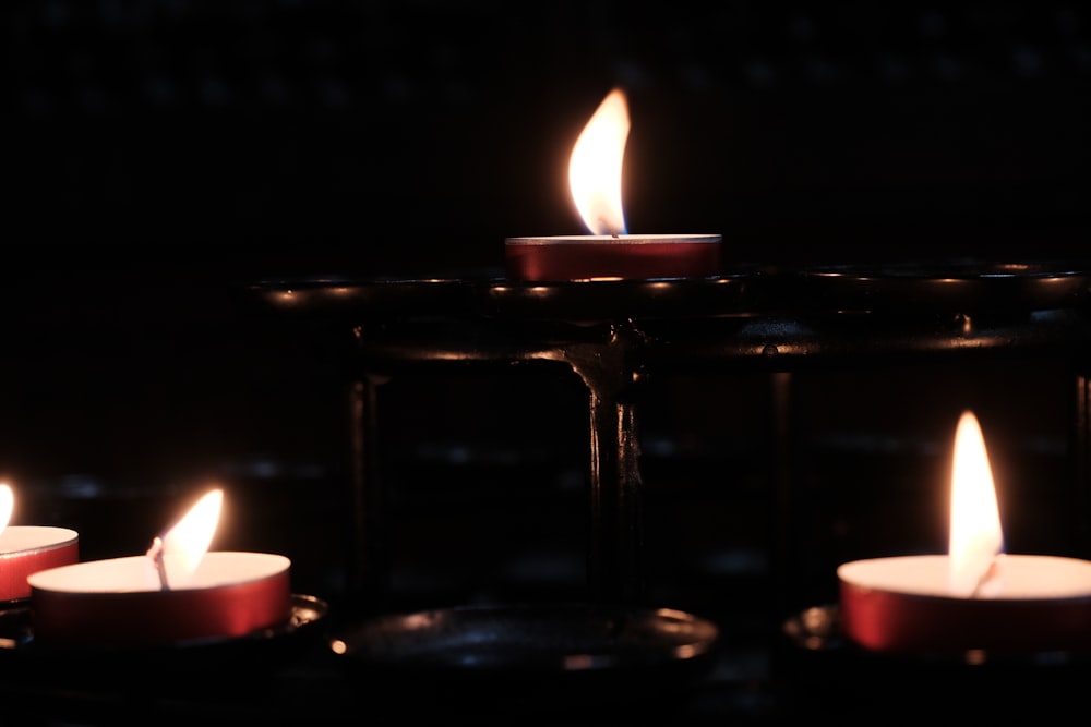 a group of lit candles sitting on top of a table