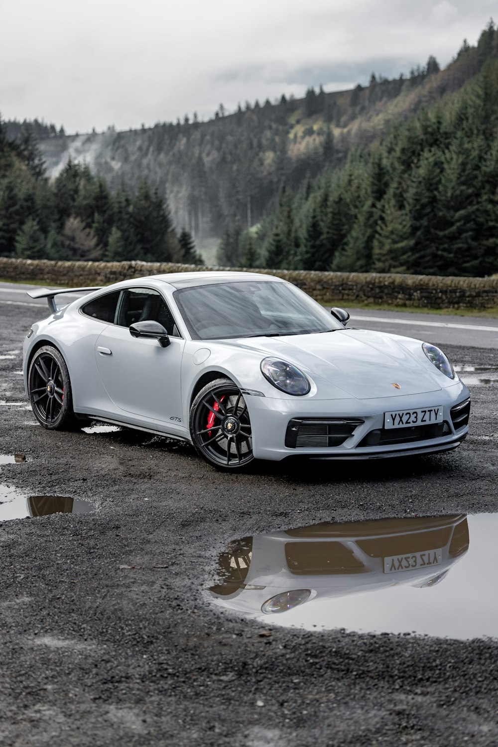 a white sports car parked in a parking lot