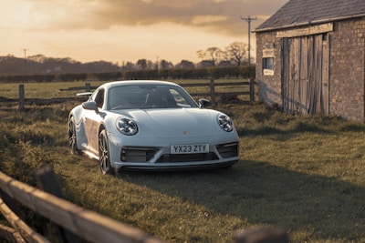 A sleek used car parked in front of the top-ag dealership on a sunny day