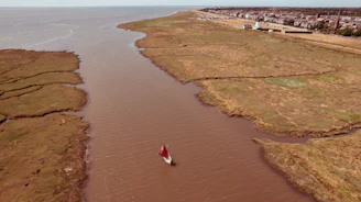 an aerial view of a boat in a body of water