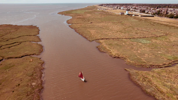 an aerial view of a boat in a body of water