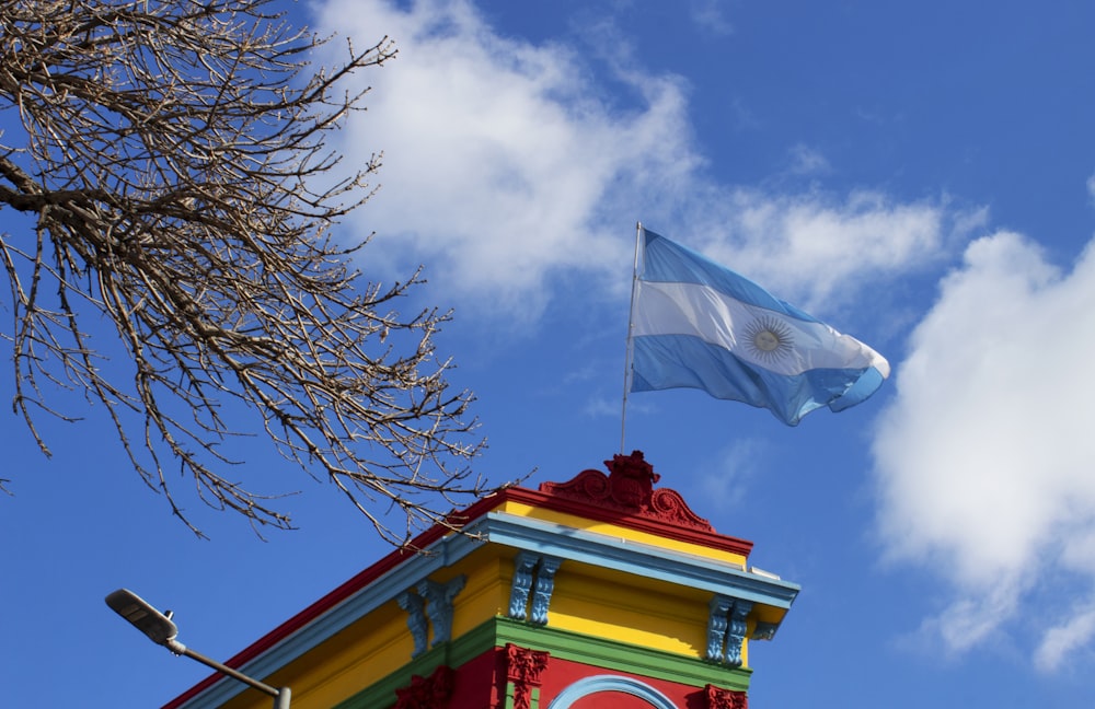 a flag flying on top of a colorful building