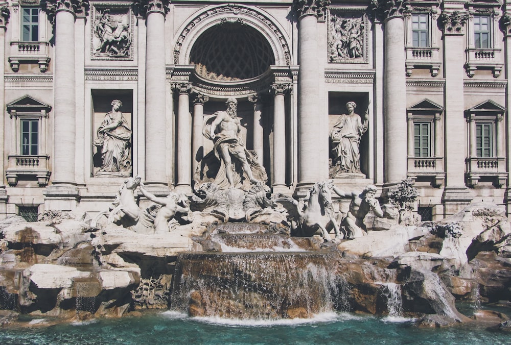 a large building with a fountain in front of it