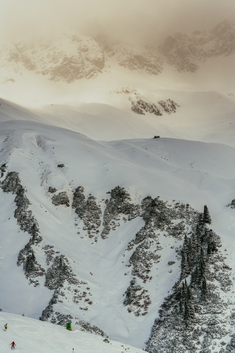 a group of people riding skis on top of a snow covered slope