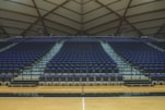 a basketball court with rows of empty seats