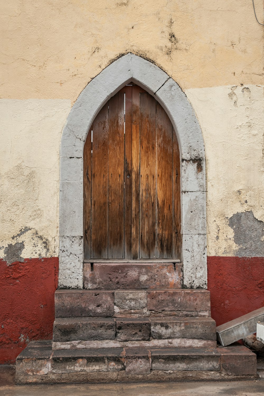a wooden door with a stone step in front of it