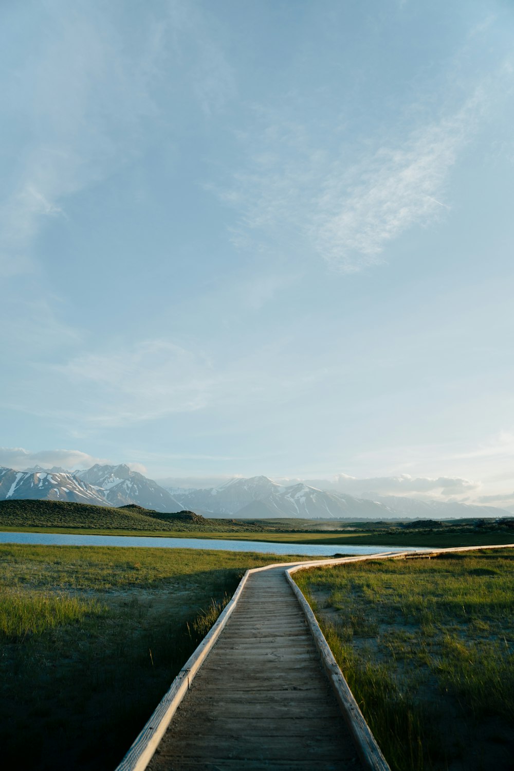 a wooden walkway leading to a body of water