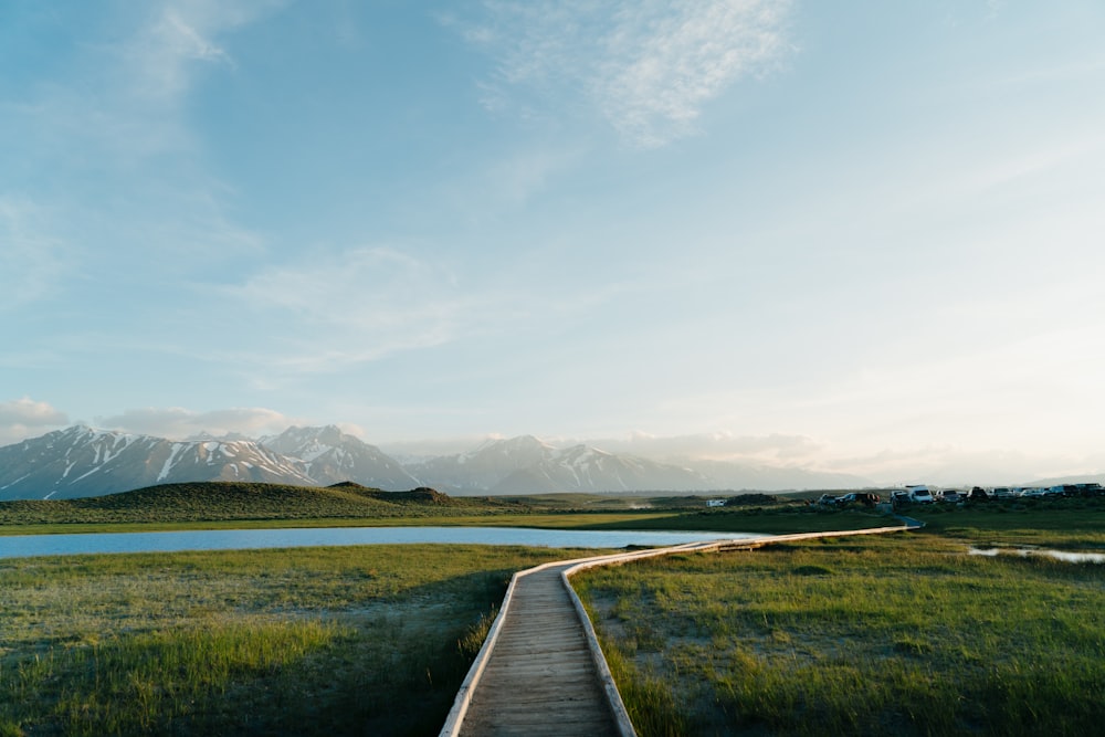 a wooden walkway leading to a body of water