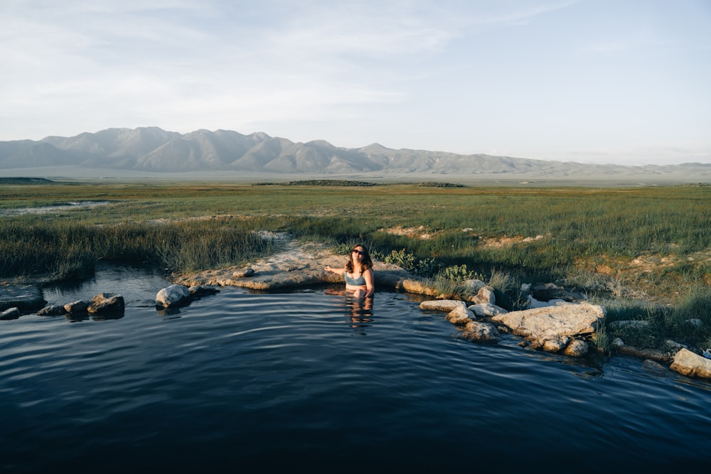 a woman standing in a body of water