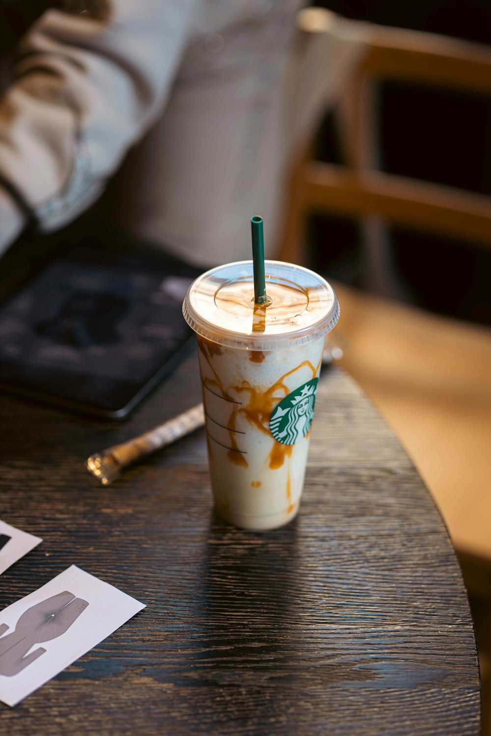 a starbucks drink sitting on top of a wooden table