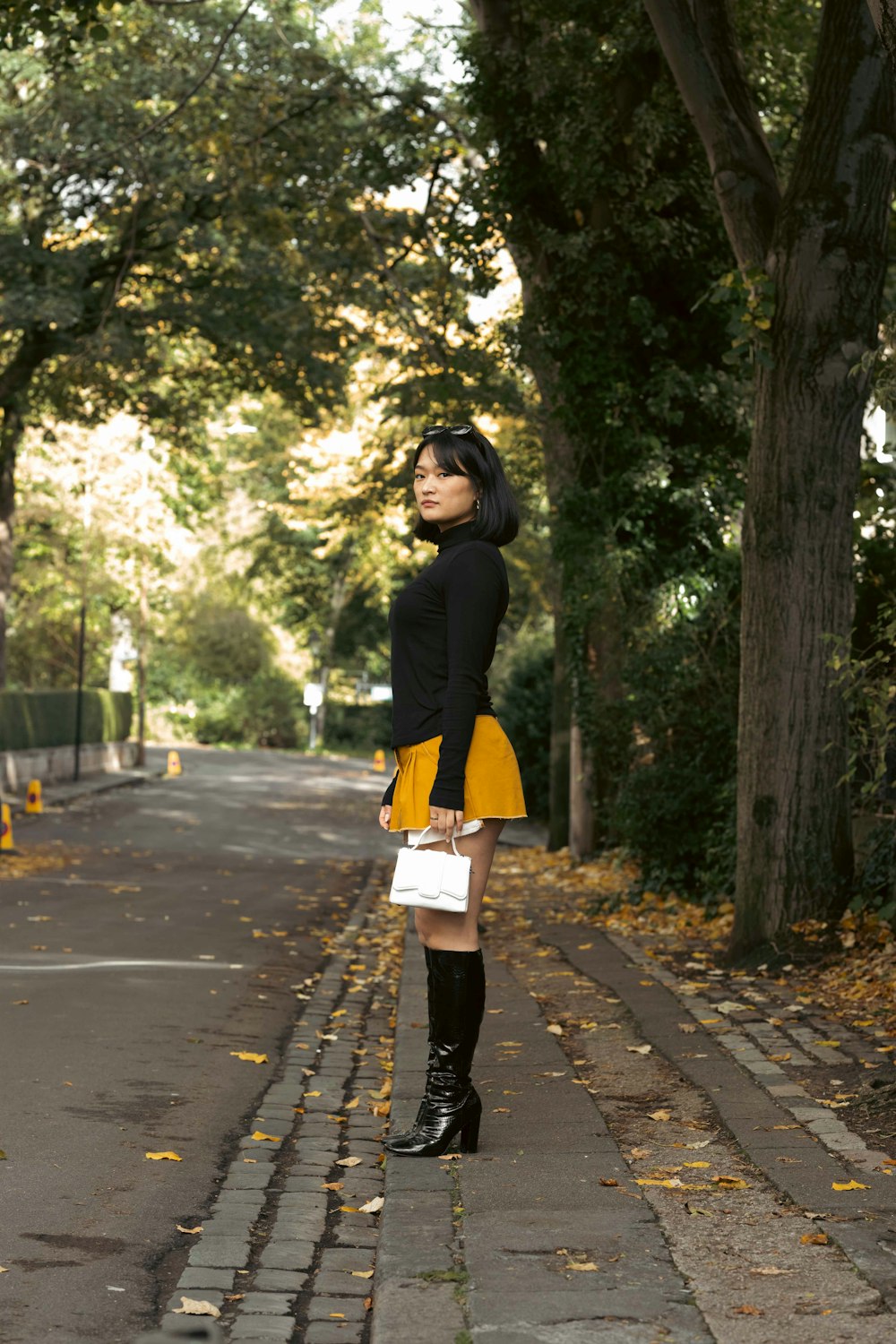 a woman in a black top and yellow skirt