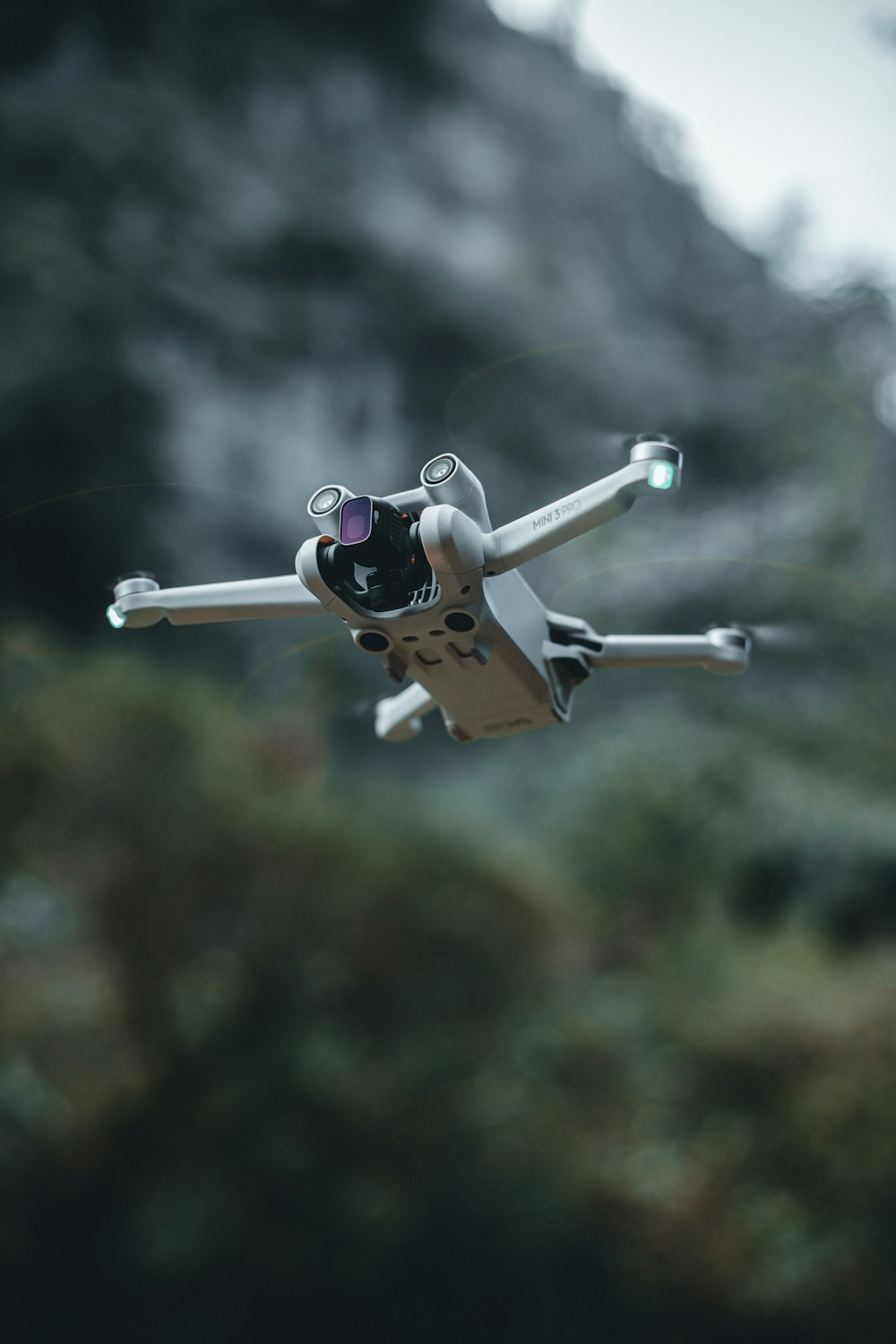 a small white and black toy airplane flying in the air