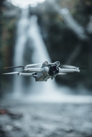 A drone flying over a flooded village delivering emergency packages.