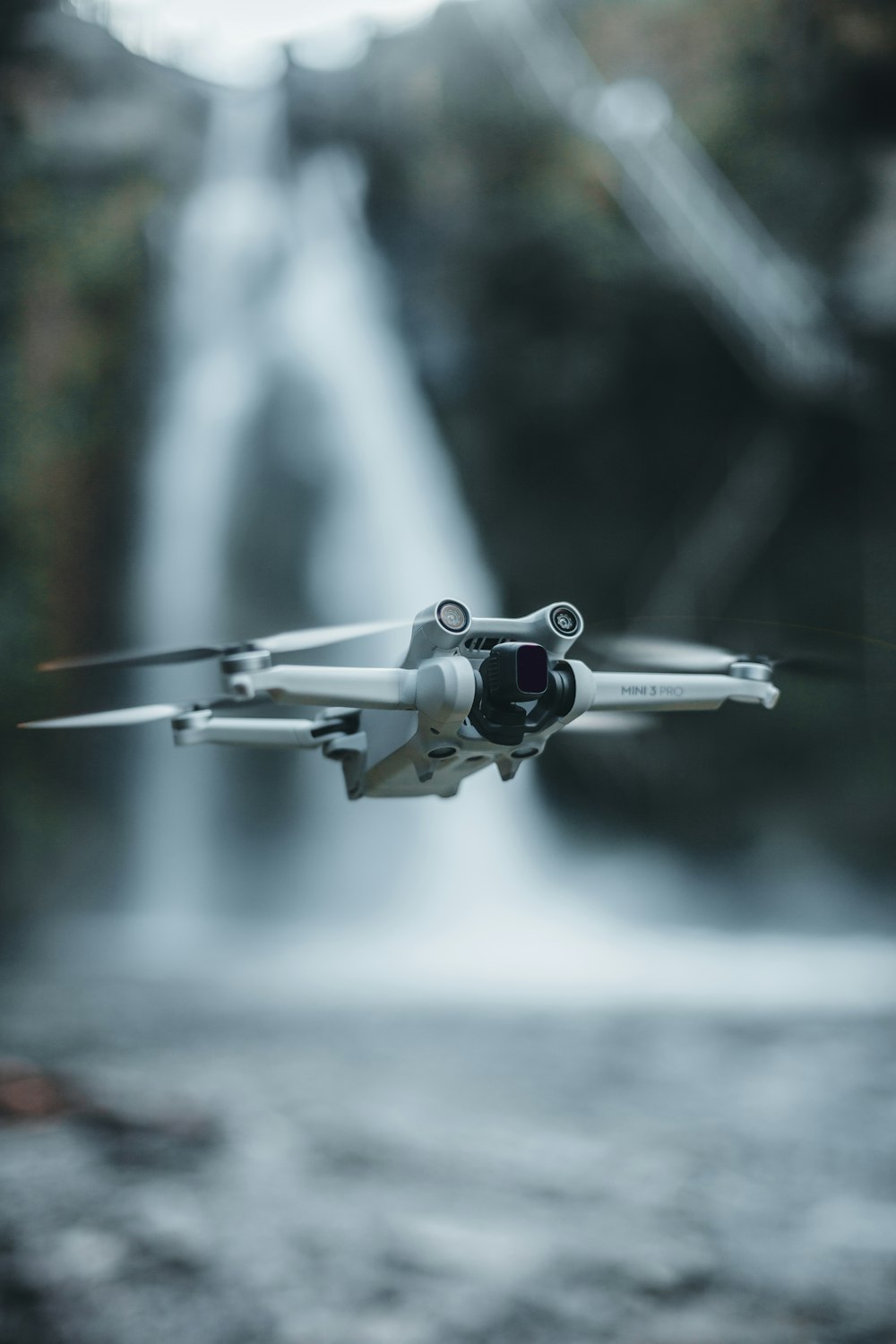a camera attached to the side of a plane flying over a waterfall