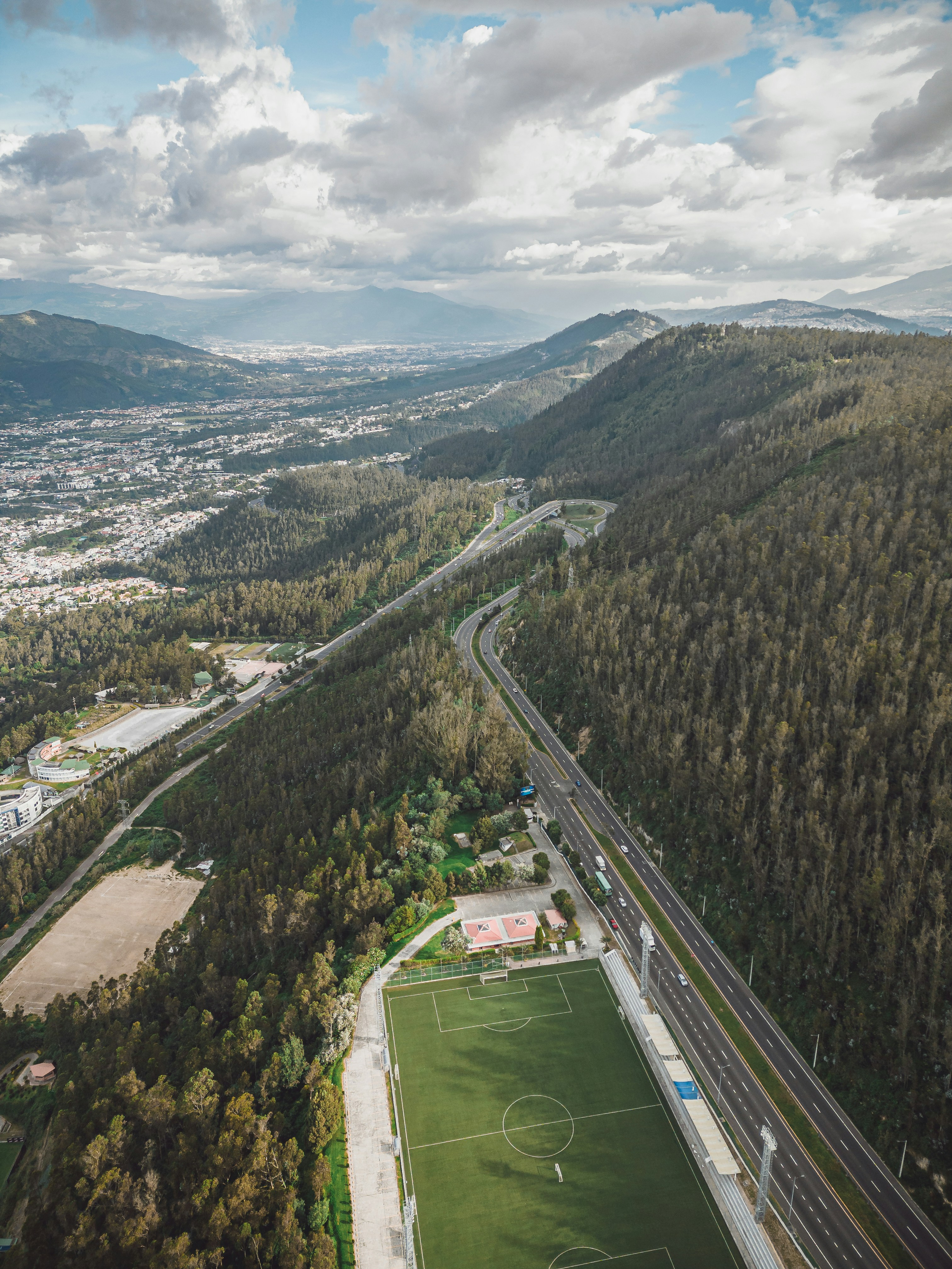 an aerial view of a soccer field in the mountains