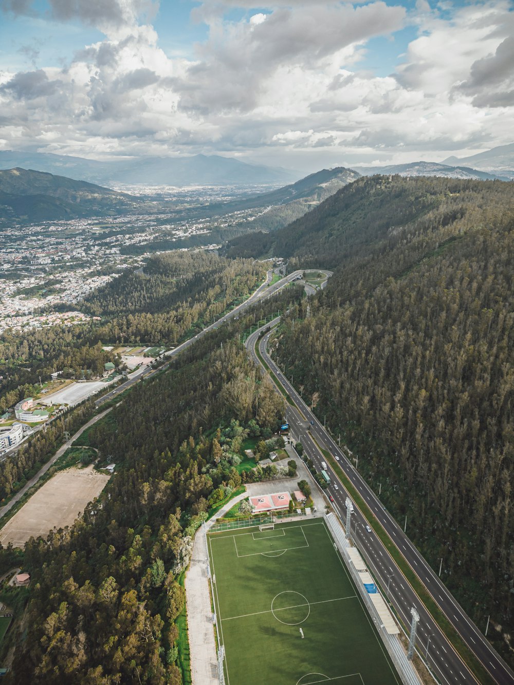 an aerial view of a soccer field in the mountains