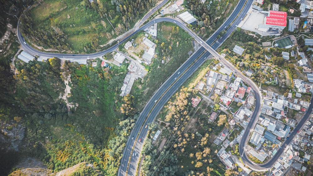 an aerial view of a winding road in a city