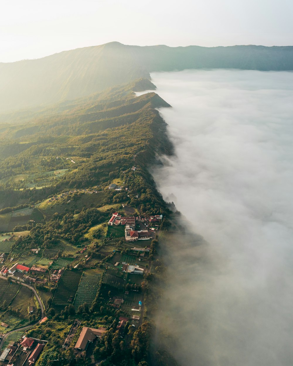 an aerial view of a town surrounded by clouds