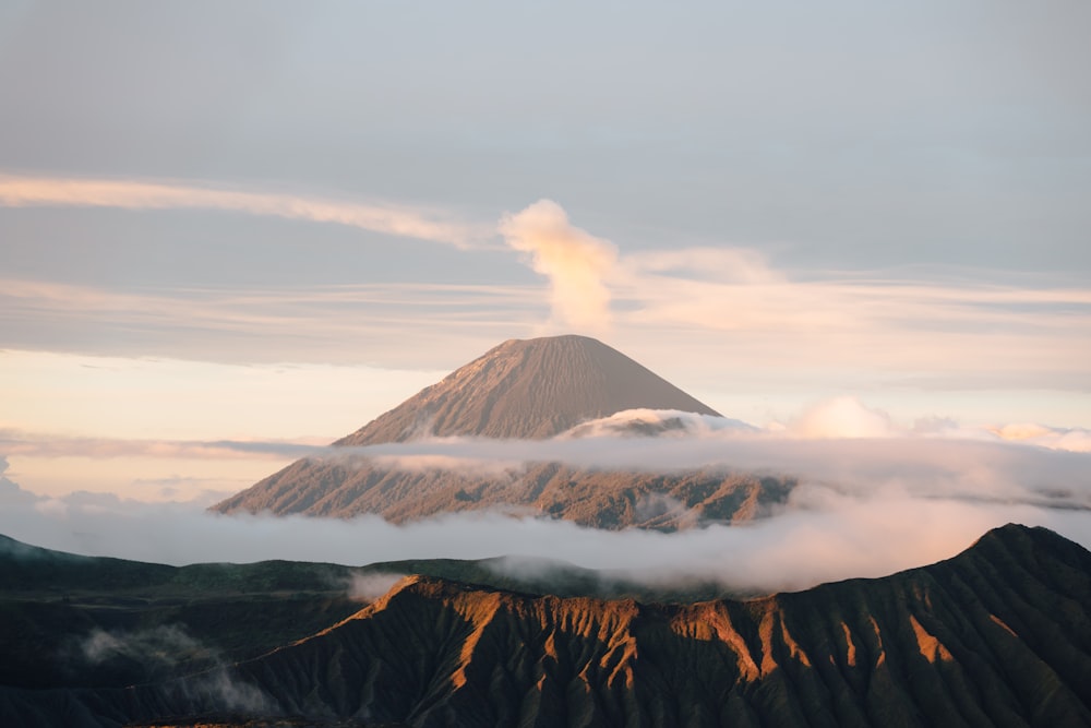 a mountain covered in clouds in the distance