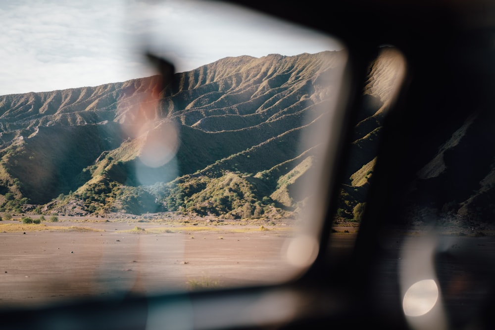 a view of a mountain from inside a vehicle