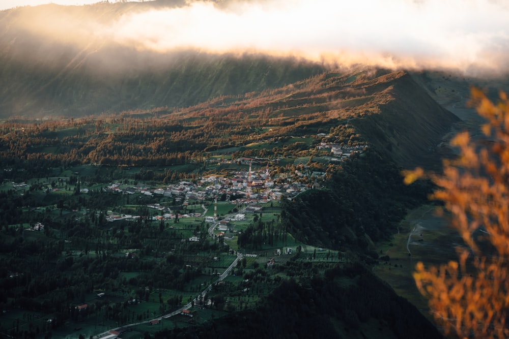 a scenic view of a small town in the mountains