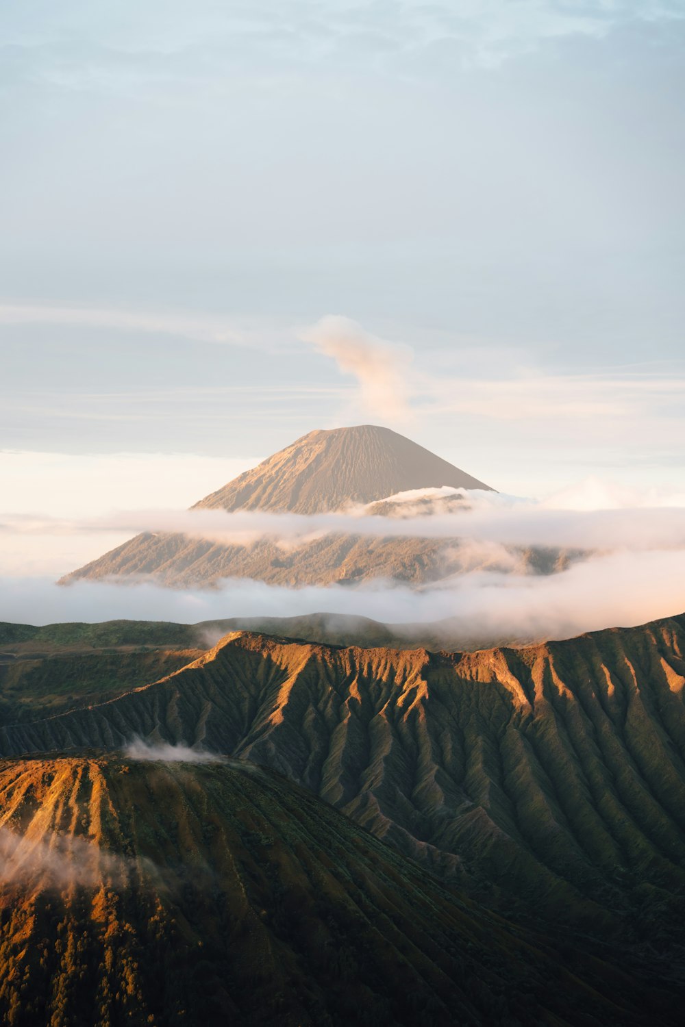 a view of a mountain covered in clouds