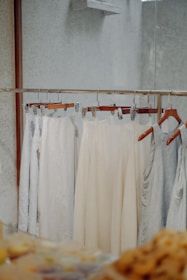 Display of finished clothing items hanging in a bright studio.
