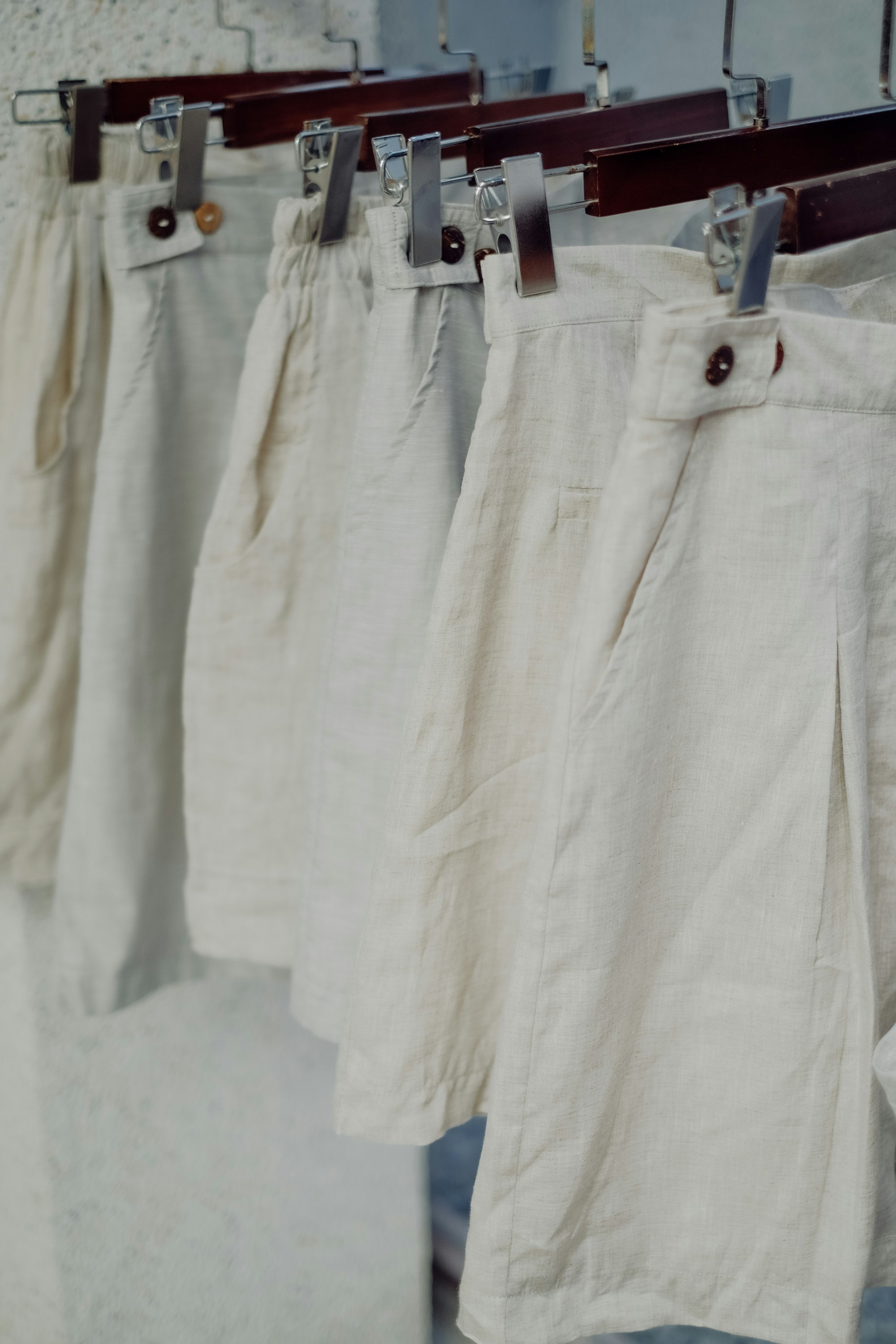 7 Common Mistakes People Make When Wearing White Clothes (And How to Avoid Them) – a row of white pants hanging on a clothes line