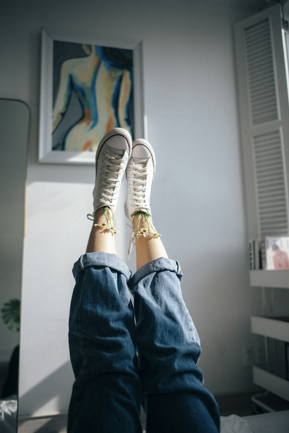 a person with their feet up on a bed